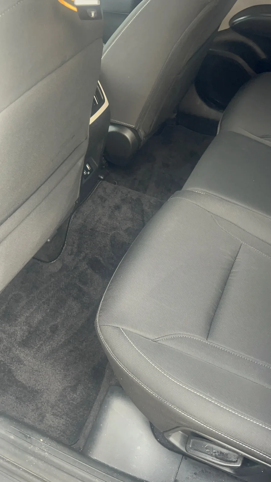 Clean rear passenger seat and carpet after an interior detail